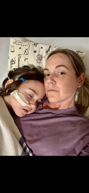Amanda holding Evelyn close during her hospital stay